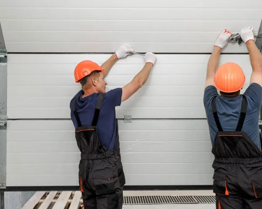 Professional technician performing a garage door opener repair service on a residential motor